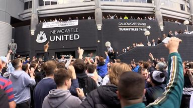 Jubilant Newcastle United fans celebrate the club's Saudi takeover outside the stadium.